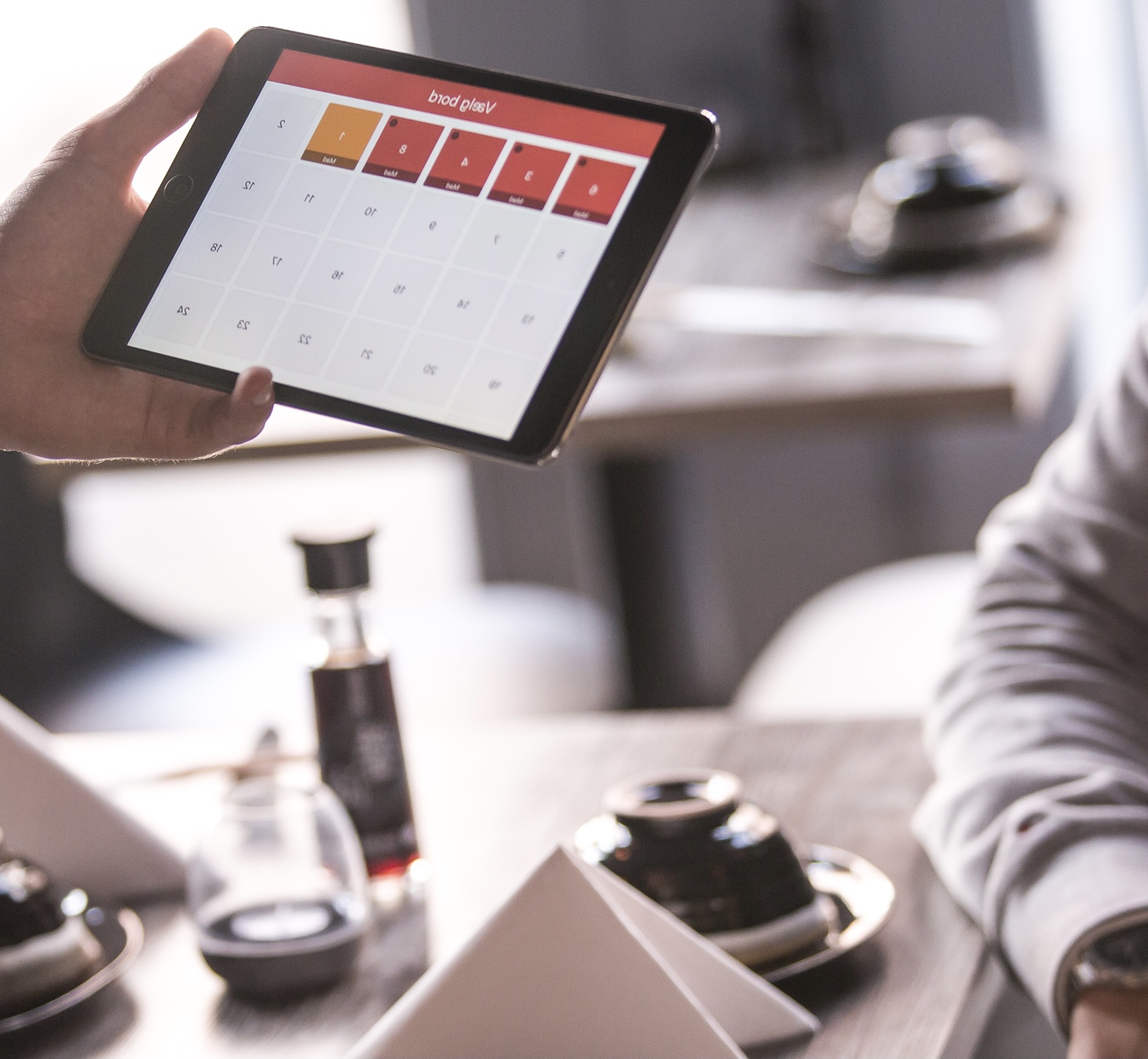 A waiter taking the order from the customer on a tablet