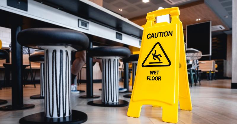 Attention wet floor sign at a restaurant