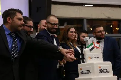 BIM POS cutting cake for their 10-year anniversary and opening a Franchise branch in UAE