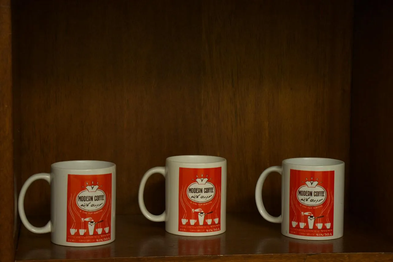 Café Younes branded mugs displayed in their café 