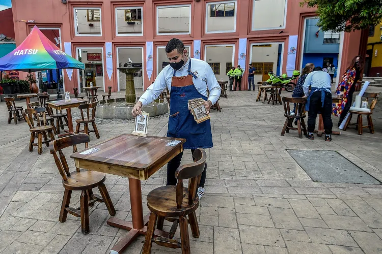The waiter is placing the tabletop that displays the QR code to scan the menu