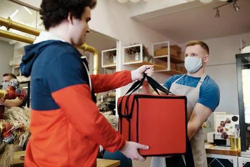 A delivery employee taking the packaged order to deliver it to customers