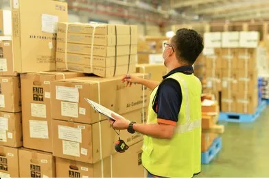 A warehouse employee performing inventory counting