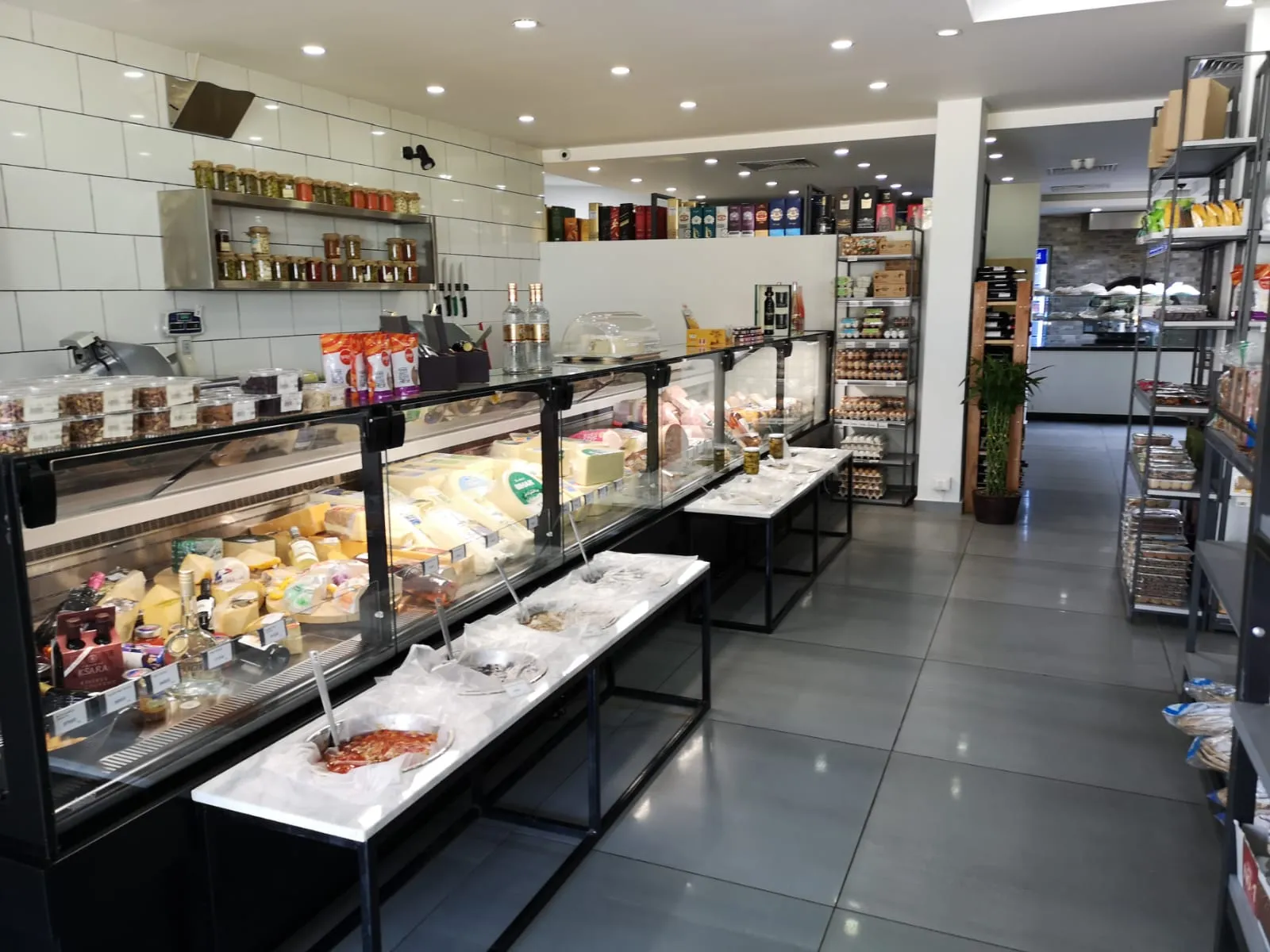 A picture of Everyday bakery café display of cheese and deli fridge 