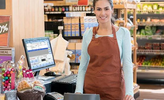 A cashier doing her job and waiting for customers to check out