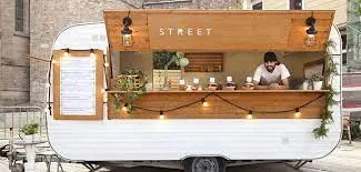 An employee serving people in a food truck business