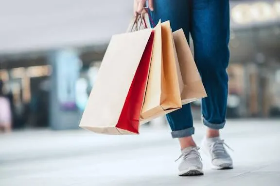A customer holding shopping bags