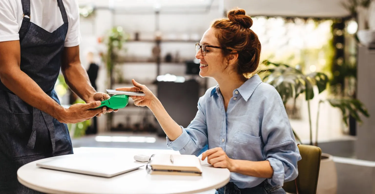 Increase customer loyalty through CRM: a waiter serving a happy customer