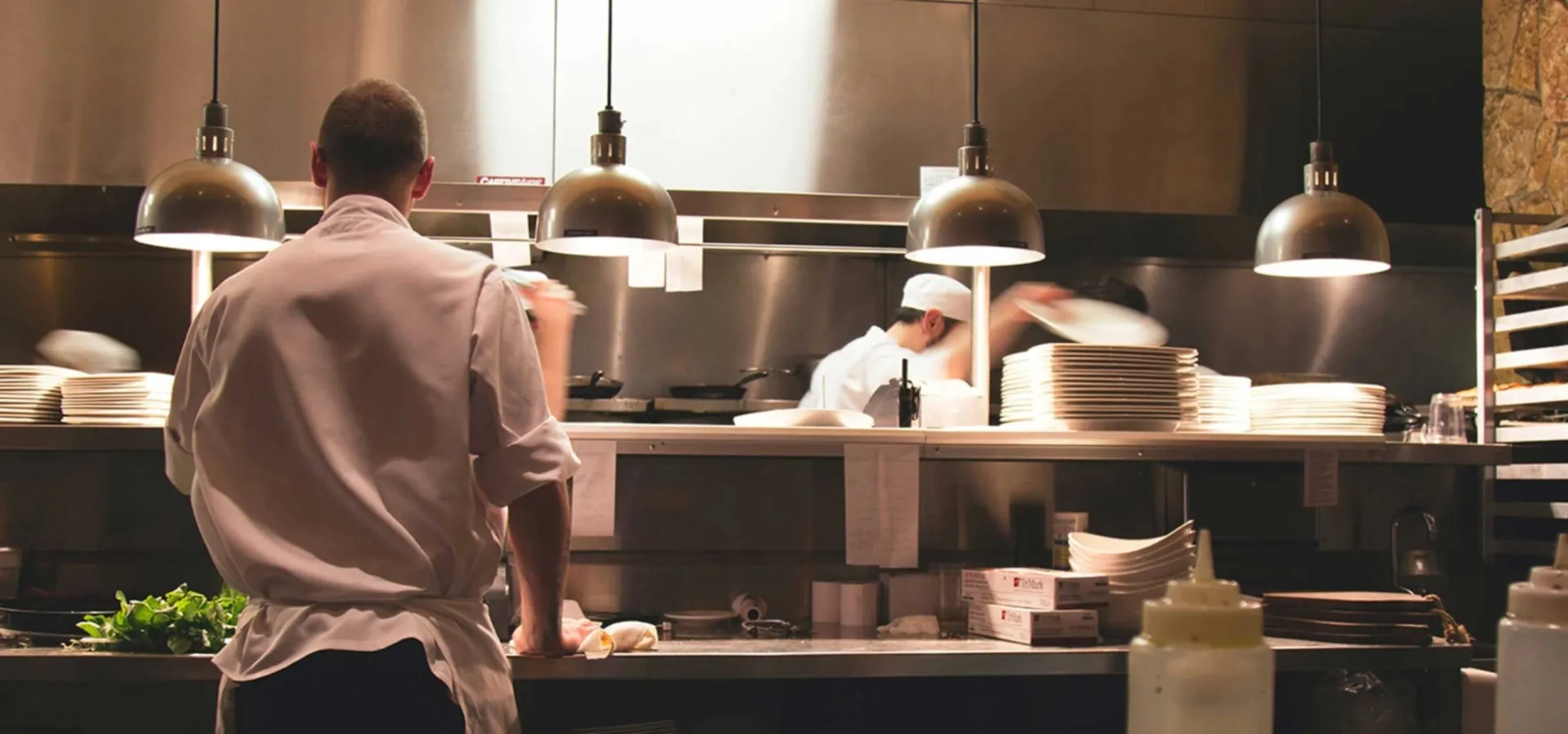 an employee or a chef working in the kitchen and preparing food