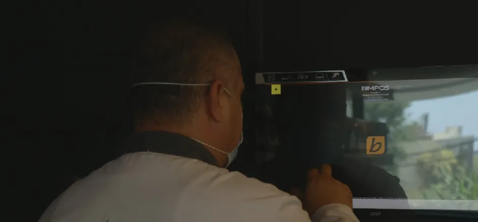 an employee working on the POS software at a restaurant