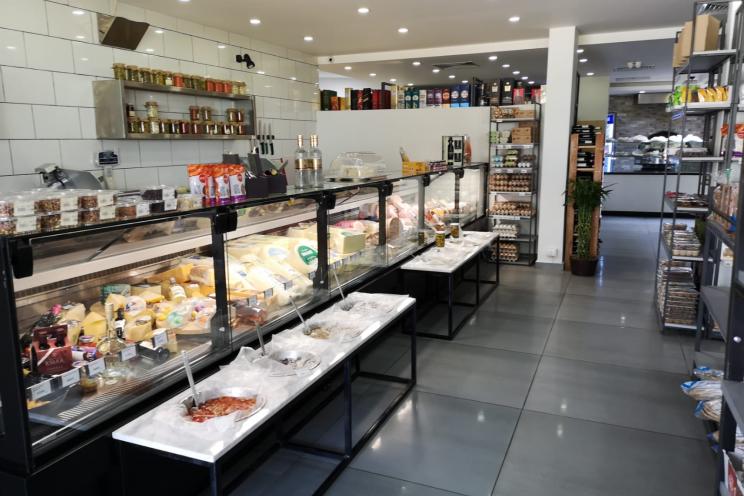 A picture of Everyday bakery café display of cheese and deli fridge 
