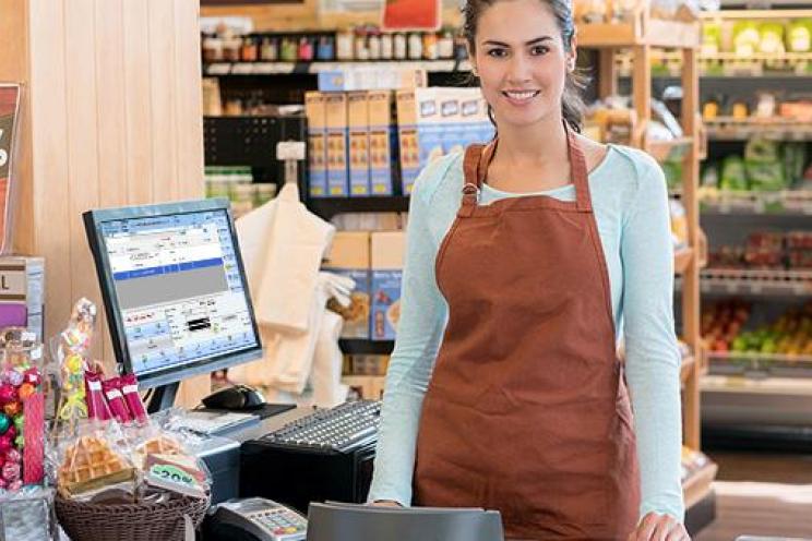 A cashier doing her job and waiting for customers to check out