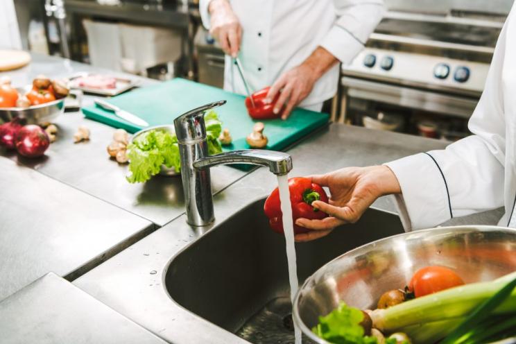 Chef preparing food and washing vegetables
