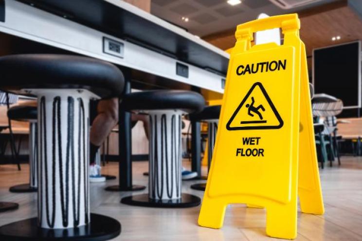 Attention wet floor sign at a restaurant