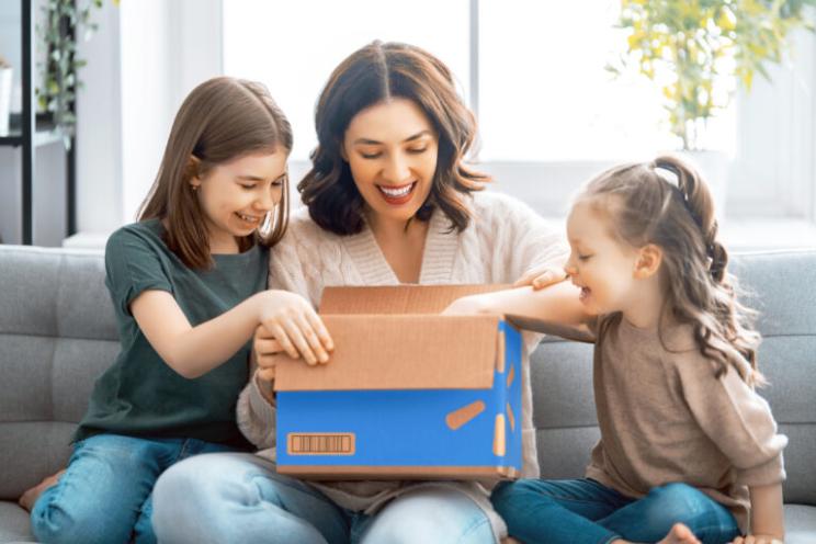 mother and daughters opening their delivery