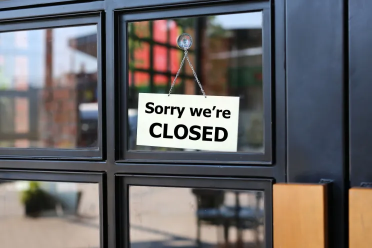 a restaurant sign showing that the restaurant is shutting down