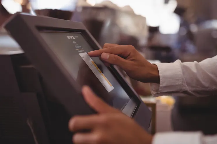 A waiter working on the restaurant management system