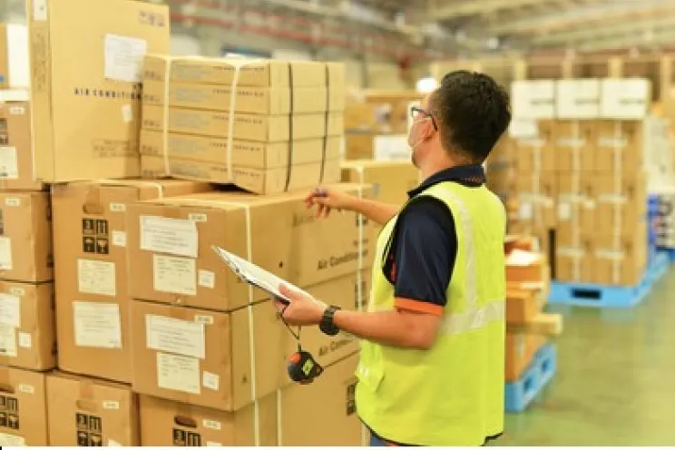 A warehouse employee performing inventory counting