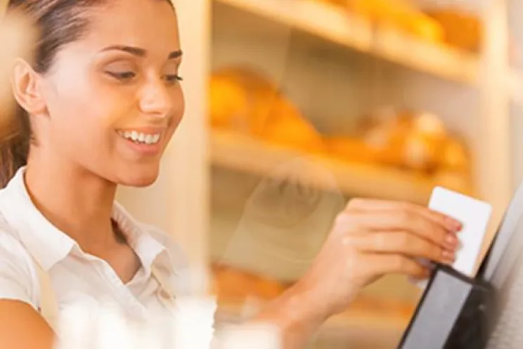 An employee swiping the debit card to process the payment
