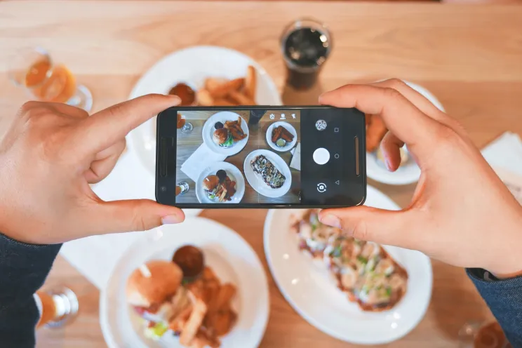 a customer taking pictures of the food at a restaurant