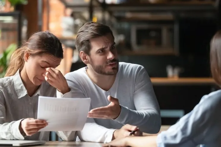 Employees dealing with an angry customer trying to solve their problem