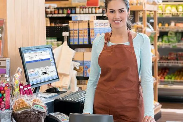 A cashier doing her job and waiting for customers to check out