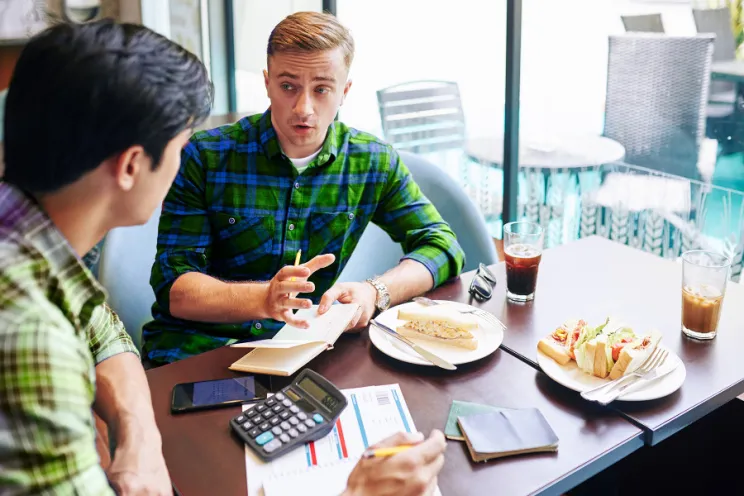 employees reviewing reports and numbers at a restaurant