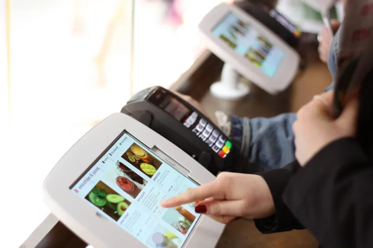 An employee working on the POS system
