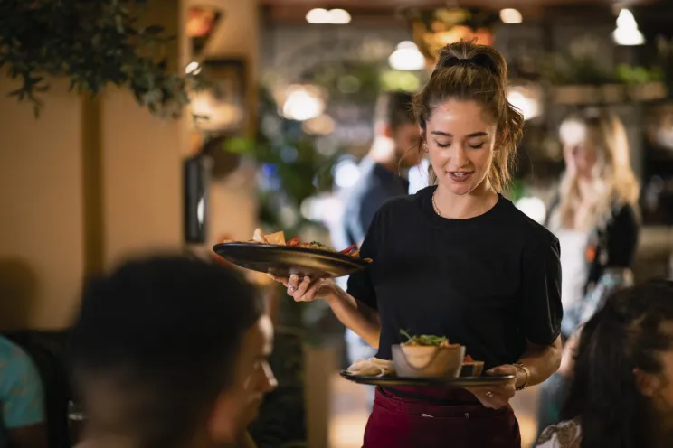 a waitress serving customers 
