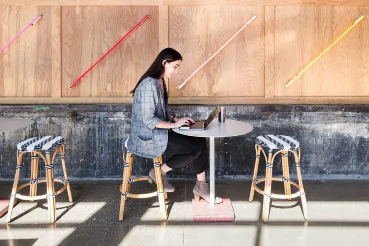 An employee working remotely from a restaurant